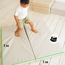 Load image into Gallery viewer, Child standing on a large beige mat with dimensions indicated, on a light wooden floor.