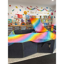 Load image into Gallery viewer, Children's play area with a rainbow-colored tarp over a cardboard box fort, surrounded by toys and books.