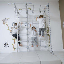 Load image into Gallery viewer, Children playing on a climbing frame in a room with wall decals.