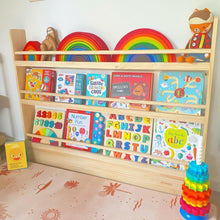 Load image into Gallery viewer, Wooden bookshelf with children's books and toys, including rainbow-colored items.
