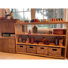 Load image into Gallery viewer, Wooden shelf with toys and baskets in a room with large windows