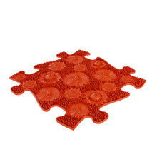 Load image into Gallery viewer, Red puzzle-shaped trivet with floral patterns on a white background
