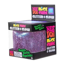 Load image into Gallery viewer, A packaged novelty squishy toy labeled 'Nice Cube Glitter &amp; Glow' in a black box with a clear front window showing a purple glitter cube inside. The packaging has colorful text and graphics on a plain white background.
