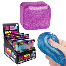 Load image into Gallery viewer, Purple glittery cube with 'Nice Dox' branding, displayed with packaging and a hand holding a blue glittery cube.

