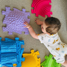 Load image into Gallery viewer, Child playing with colorful textured floor mats on a carpeted floor
