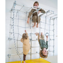 Load image into Gallery viewer, Children playing on a climbing frame indoors with a yellow mat below.
