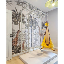 Load image into Gallery viewer, Children's play area with a giraffe-themed swing and wall decals of giraffes and palm trees.
