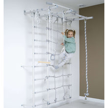 Load image into Gallery viewer, Child climbing on a play structure with ropes and ladder indoors.
