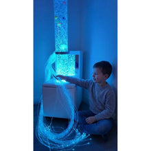 Load image into Gallery viewer, Child interacting with a fiber optic light display in a room with blue lighting.
