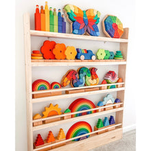 Load image into Gallery viewer, Colorful wooden toys on a wooden shelf against a white wall
