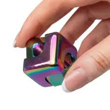 Load image into Gallery viewer, Hand holding a rainbow-colored fidget spinner on a white background
