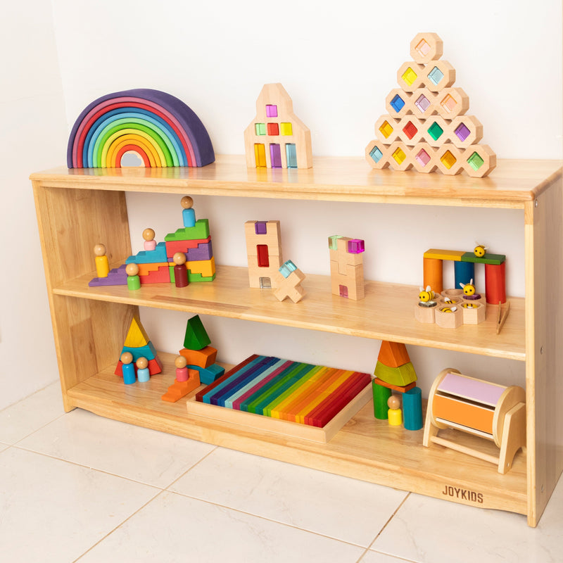 Wooden shelf with colorful children's toys on a light background